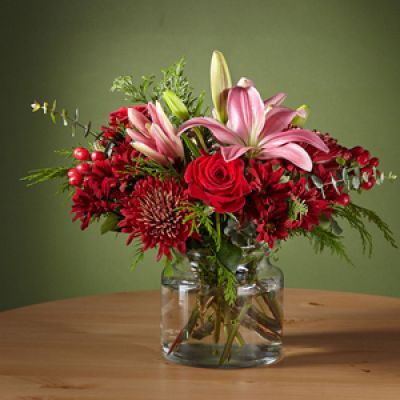 Make your loved ones blush with this Rosy Cheeks Bouquet, outfitted with stunning red roses and lilies. Cute enough to pinch, this gift will bring a flirtatious pop of color to a traditional holiday palette and kick the Christmas gathering off right.