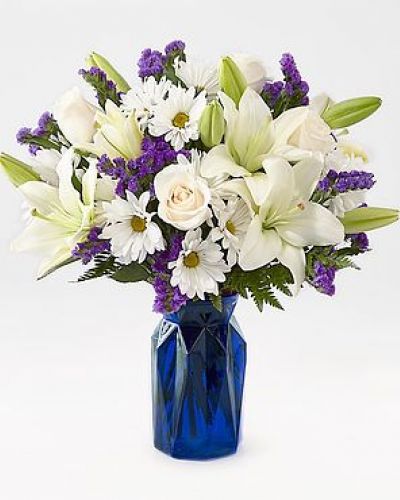 Gift your friends and family the freshest and most beautiful bouquet of lilies, roses and statice. Perfect for complementing any message you want to send, our Beyond Blue Bouquet features a deep blue vase and a gorgeous array of white and purple blooms.
STANDARD
C Quantity Color Description
3 Ivory 50 cm Standard Rose - Escimo
2 White LA Hybrid Lily
5 White Daisy Pom
3 Purple Filler - Sinuata Statice
3 Green Green - Leather Leaf
DELUXE
C Quantity Color Description
5 Ivory 50 cm Standard Rose - Escimo
3 White LA Hybrid Lily
5 White Daisy Pom
4 Purple Filler - Sinuata Statice
3 Green Green - Leather Leaf
PREMIUM
C Quantity Color Description
6 Ivory 50 cm Standard Rose - Escimo
4 White LA Hybrid Lily
5 White Daisy Pom
4 Purple Filler - Sinuata Statice
3 Green Green - Leather Leaf