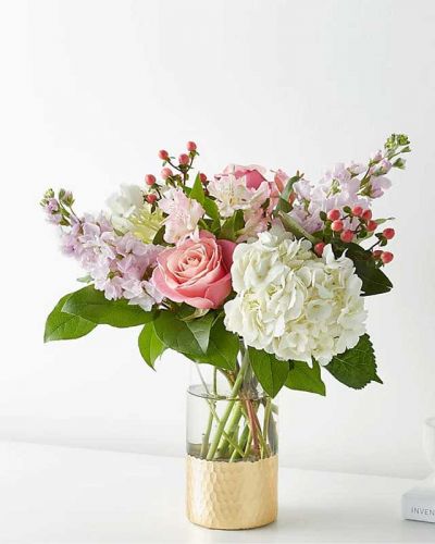<p>Tickle them pink with this elegant arrangement of roses, alstroemeria, hypericum berries, and carnations set in a gold–dipped vase. As elegant as a string of pearls, add a touch of class to any room with roses and gerbera daisies.</p>
