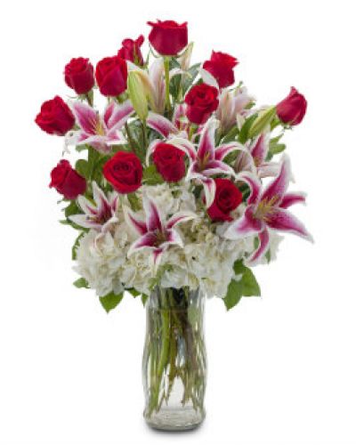 Deliver inspiration to your special someone with this classically gorgeous arrangement of a dozen red roses accented with lilies and hydrangea.
