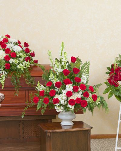 Red and white casket spray, urn and wreath.