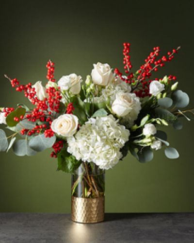 String boughs of holly throughout your home with our Winter Forest Bouquet. Anticipate dynamic movement with a diverse gathering of white roses, hydrangea, lisianthus, crimson ilex berries and wooded greenery for a dazzling holiday.