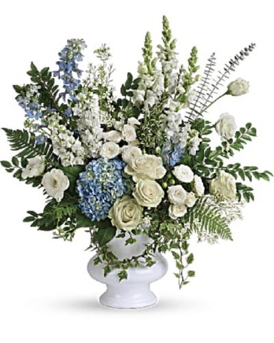 <div class="m-pdp-tabs-description">
<div id="mark-1" class="m-pdp-tabs-marketing-description">A treasured tribute to your beloved, this gorgeously grand bouquet of soft blue hydrangea and pure white roses is reminiscent of a clear sky, a hopeful reminder of life and love.</div>
</div>
<p id="arrngDescp">This beautiful bouquet of light blue hydrangea, white roses, white spray roses, white lisianthus, light blue delphinium, white snapdragons, white stock, and white waxflower is accented with huckleberry, variegated ivy, spiral eucalyptus, dagger fern, and lemon leaf. Delivered in a white designer urn.</p>